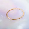Rose Fairtrade Gold Flat Oval Forged Bangle by Cox and Power jewellers London