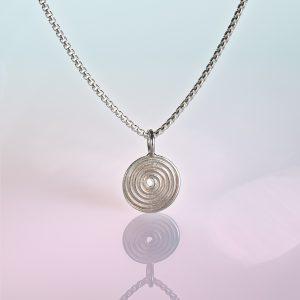 Spiral Pendant in Silver, shown with silver box chain on gradient blue to pink background.