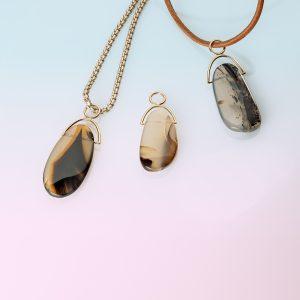 Montana Agate Drop in 18ct Yellow Gold with silver box chain. shown on gradient blue-to-pink background.