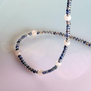 Iolite and Frosted Rose Quartz Necklace with Silver Bayonet Clasp. Shown against a gradient backround from blue to pink.