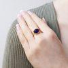 oval amethyst cabochon (4.46ct) in 18ct yellow gold shown on model hand