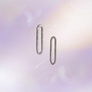 Pair of elongated oval link-shaped stud earrings in textured silver, shown against a soft pastel background.