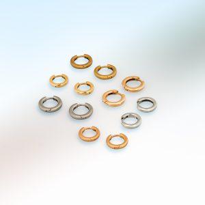 Group shot of small hinged hoop earrings in platinum, 18ct yellow gold, and 18ct rose gold, arranged on a soft gradient background