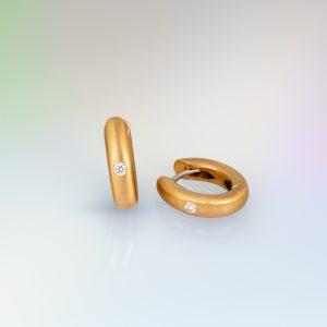 Pair of oval hinged hoop earrings in brushed 18ct yellow gold, each set with a single round diamond.