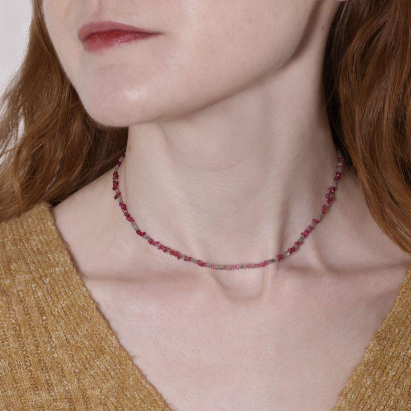 Model photo of a red spinel and diamond cube necklace