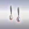 A pair of silver earrings with oval peach-pink coloured natural pearl drops