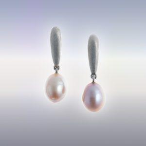 A pair of silver earrings with oval peach-pink coloured natural pearl drops